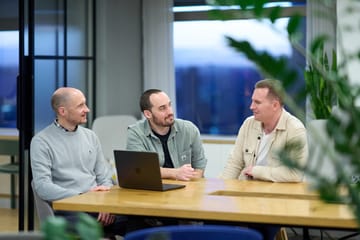 Ryan, Tom and Lee together in a workplace setting.